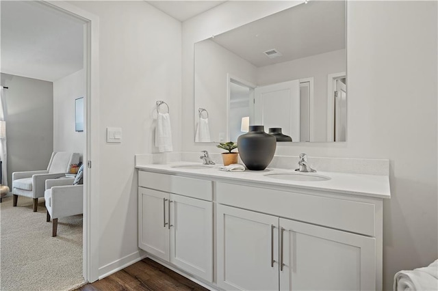 21807 Lucca Ln, Peculiar, MO 64078 - bathroom featuring double vanity and wood finished floors