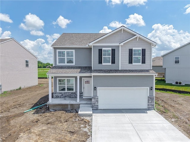 21807 Lucca Ln, Peculiar, MO 64078 - craftsman-style house featuring concrete driveway, stone siding, an attached garage, roof with shingles, and a porch