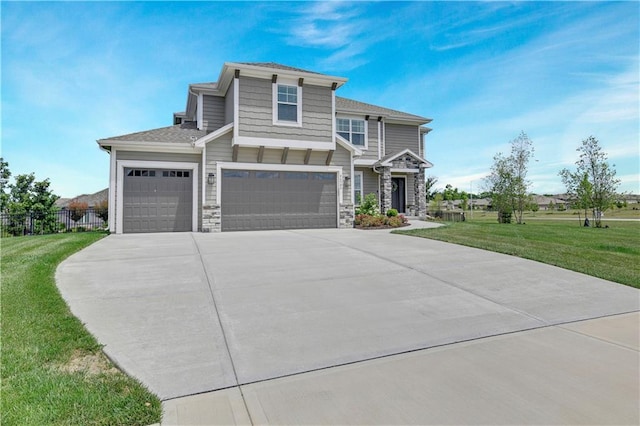 24704 W 76th St, Shawnee, KS 66227 - view of front of house with stone siding, driveway, and an attached garage