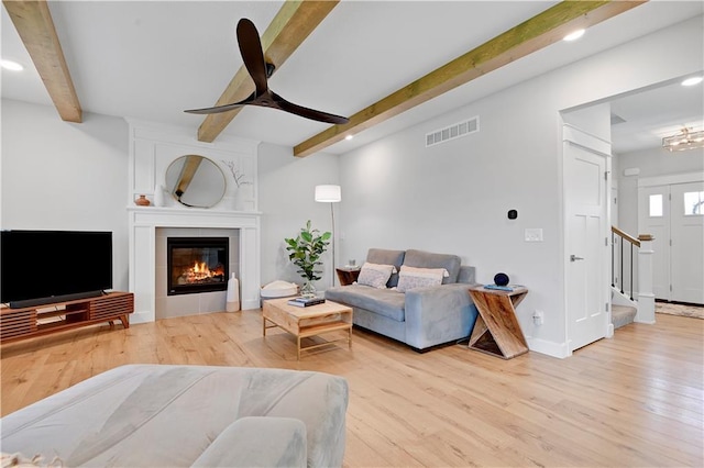 24704 W 76th St, Shawnee, KS 66227 - living area featuring beam ceiling, wood finished floors, ceiling fan, recessed lighting, and a fireplace