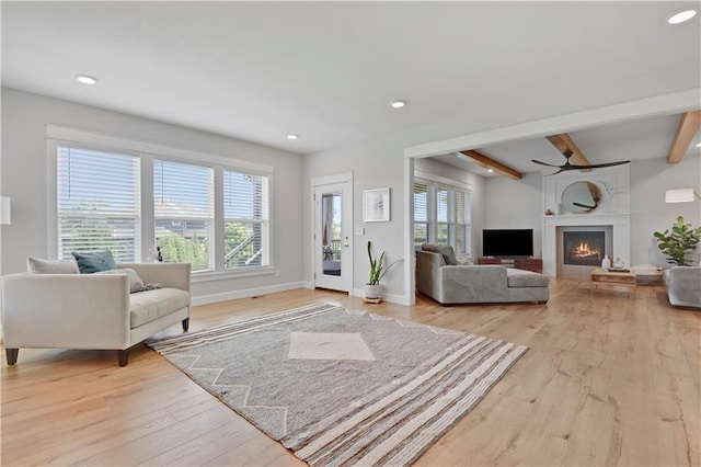 24704 W 76th St, Shawnee, KS 66227 - living room with light wood-type flooring, beamed ceiling, a large fireplace, ceiling fan, and recessed lighting