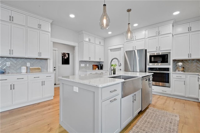 24704 W 76th St, Shawnee, KS 66227 - kitchen featuring stainless steel appliances, tasteful backsplash, white cabinetry, hanging light fixtures, and recessed lighting