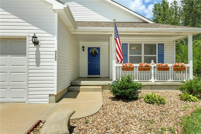4204 Broadway Ter, Leavenworth, KS 66048 - view of exterior entry featuring a porch, a garage, and a shingled roof