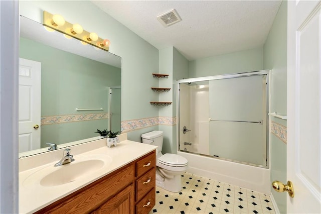 4204 Broadway Ter, Leavenworth, KS 66048 - bathroom with vanity, shower / bath combination with glass door, tile patterned floors, and a textured ceiling