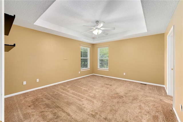 4204 Broadway Ter, Leavenworth, KS 66048 - carpeted spare room featuring a textured ceiling, a raised ceiling, and a ceiling fan
