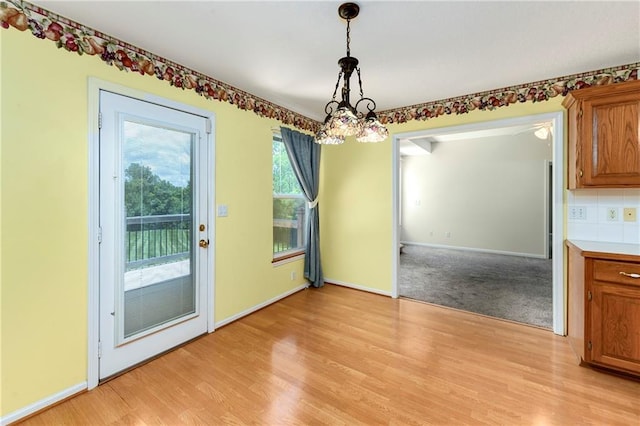 4204 Broadway Ter, Leavenworth, KS 66048 - unfurnished dining area with a chandelier and light wood-style floors