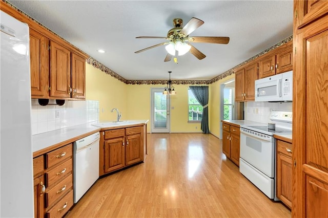 4204 Broadway Ter, Leavenworth, KS 66048 - kitchen with white appliances, brown cabinetry, light wood-style floors, a ceiling fan, and recessed lighting