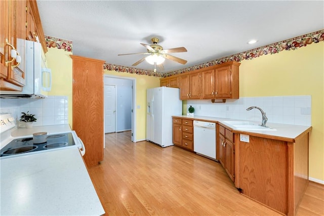 4204 Broadway Ter, Leavenworth, KS 66048 - kitchen with white appliances, light countertops, ceiling fan, and backsplash