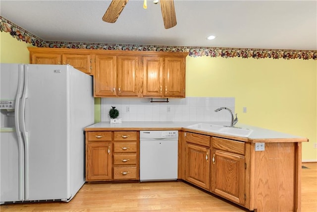 4204 Broadway Ter, Leavenworth, KS 66048 - kitchen with white appliances, a peninsula, brown cabinets, and a ceiling fan