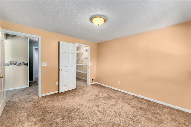 4204 Broadway Ter, Leavenworth, KS 66048 - unfurnished bedroom with a textured ceiling, carpet flooring, and a spacious closet