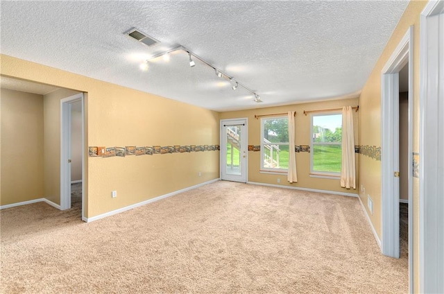 4204 Broadway Ter, Leavenworth, KS 66048 - empty room with light carpet, rail lighting, and a textured ceiling