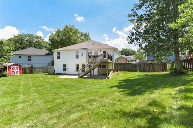 4204 Broadway Ter, Leavenworth, KS 66048 - back of property featuring a fenced backyard, stairs, a storage shed, and a patio