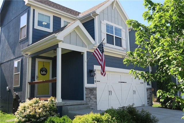 SW 8th St Unit 8819, Blue Springs, MO 64064 - craftsman-style house with board and batten siding, an attached garage, concrete driveway, stone siding, and a shingled roof