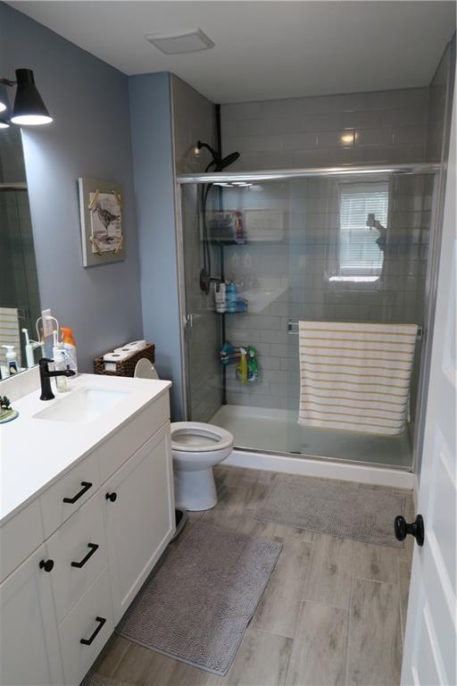 SW 8th St Unit 8819, Blue Springs, MO 64064 - bathroom with vanity and a shower stall