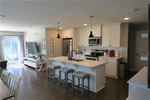 SW 8th St Unit 8819, Blue Springs, MO 64064 - kitchen featuring stainless steel appliances, a breakfast bar area, white cabinetry, light countertops, and tasteful backsplash