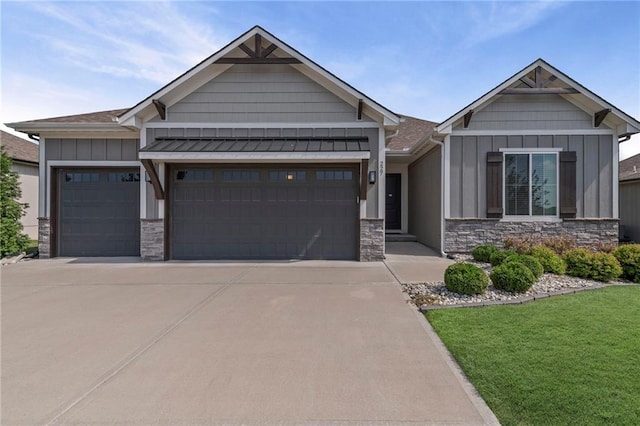 227 SW Eagles Ridge Dr, Blue Springs, MO 64014 - craftsman-style home featuring stone siding, board and batten siding, an attached garage, a front yard, and concrete driveway