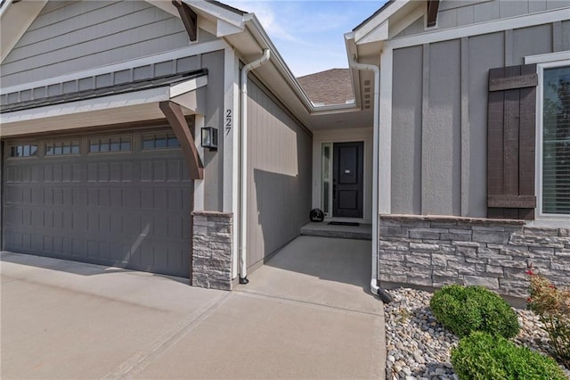 227 SW Eagles Ridge Dr, Blue Springs, MO 64014 - entrance to property featuring stone siding, driveway, and an attached garage
