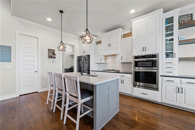227 SW Eagles Ridge Dr, Blue Springs, MO 64014 - kitchen with stainless steel double oven, gas stovetop, ornamental molding, backsplash, and a kitchen breakfast bar