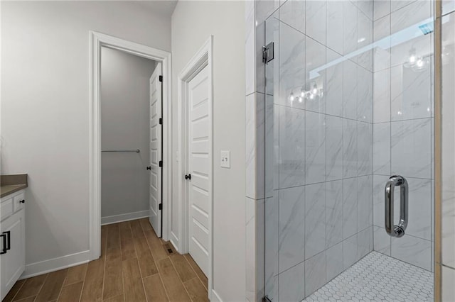 227 SW Eagles Ridge Dr, Blue Springs, MO 64014 - bathroom featuring wood finished floors, a stall shower, and vanity