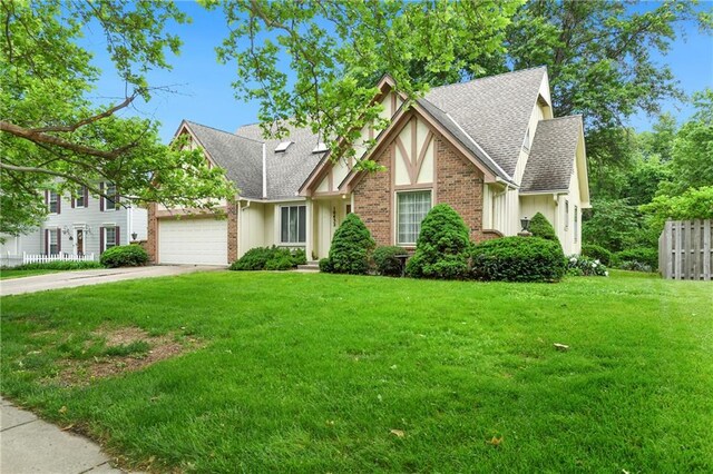 10432 Bond St, Overland Park, KS 66214 - view of front facade featuring a shingled roof, an attached garage, board and batten siding, and driveway