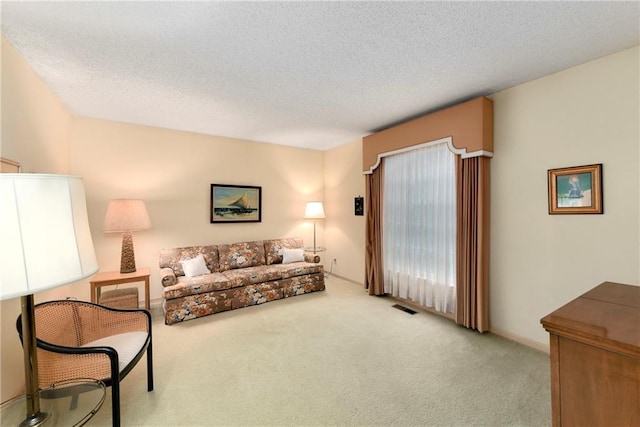10432 Bond St, Overland Park, KS 66214 - carpeted living area featuring a textured ceiling