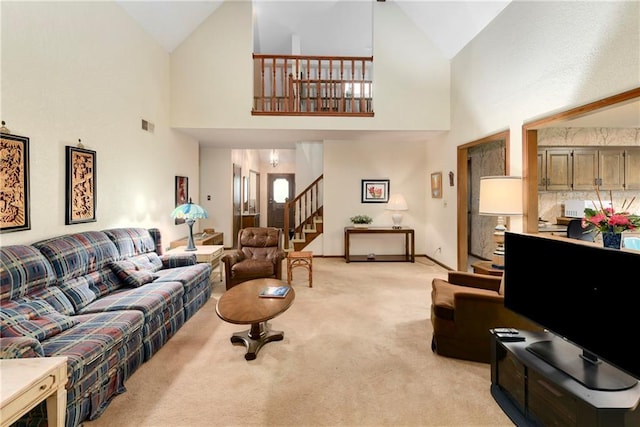 10432 Bond St, Overland Park, KS 66214 - living room with stairway, light carpet, and high vaulted ceiling