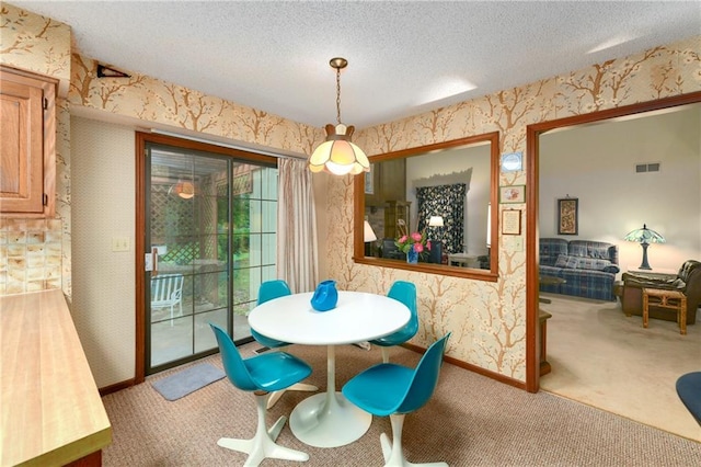 10432 Bond St, Overland Park, KS 66214 - dining space featuring wallpapered walls, light carpet, and a textured ceiling