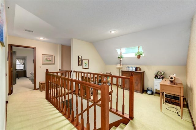 10432 Bond St, Overland Park, KS 66214 - hall featuring an upstairs landing, light colored carpet, vaulted ceiling, and recessed lighting