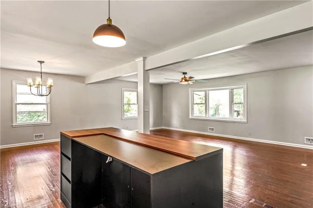 1480 E 76th Ter, Kansas City, MO 64131 - kitchen with dark cabinetry, plenty of natural light, dark wood-style flooring, and ceiling fan