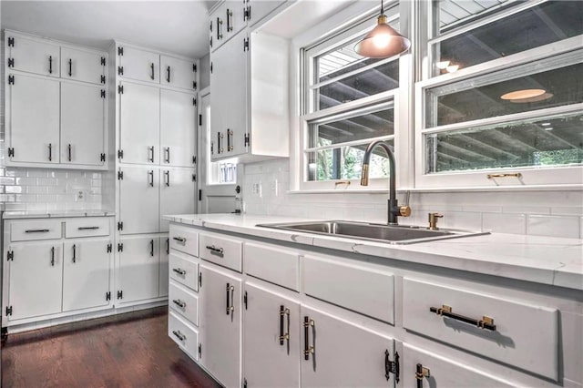 1480 E 76th Ter, Kansas City, MO 64131 - kitchen with tasteful backsplash, white cabinetry, dark wood-style floors, and light stone counters