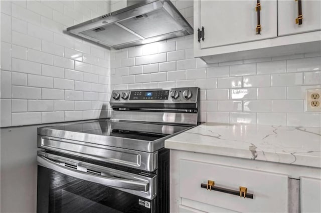 1480 E 76th Ter, Kansas City, MO 64131 - kitchen with stainless steel range with electric cooktop, ventilation hood, backsplash, and light stone countertops