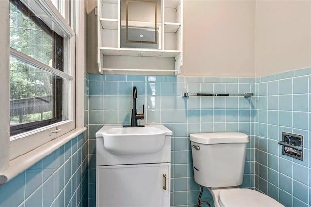 1480 E 76th Ter, Kansas City, MO 64131 - half bathroom with tile walls, vanity, and healthy amount of natural light