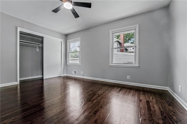 1480 E 76th Ter, Kansas City, MO 64131 - unfurnished bedroom with multiple windows, wood finished floors, a closet, and ceiling fan