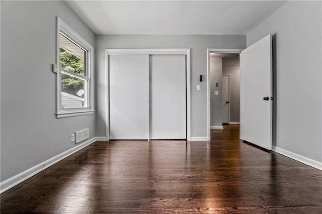 1480 E 76th Ter, Kansas City, MO 64131 - unfurnished bedroom with a closet and wood finished floors