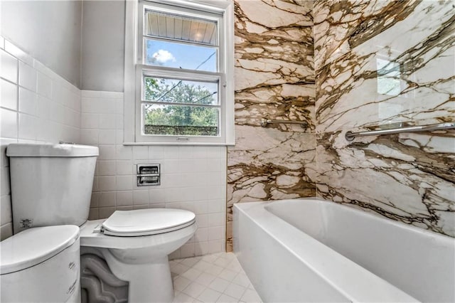 1480 E 76th Ter, Kansas City, MO 64131 - bathroom with tile walls, a bath, and tile patterned flooring