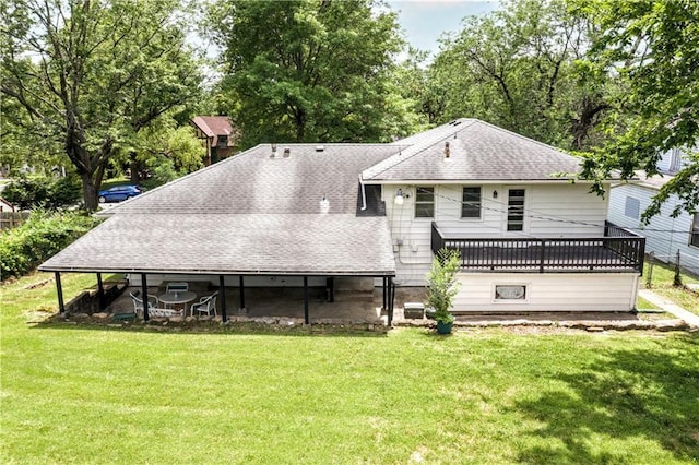 1480 E 76th Ter, Kansas City, MO 64131 - rear view of property featuring a shingled roof and a lawn