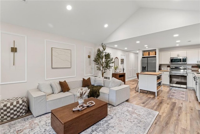 521 E Bird St, Hamilton, MO 64644 - living area featuring light wood-style flooring, recessed lighting, and high vaulted ceiling