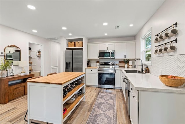 521 E Bird St, Hamilton, MO 64644 - kitchen featuring appliances with stainless steel finishes, open shelves, wood counters, white cabinets, and recessed lighting