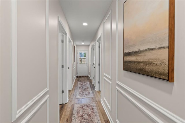 521 E Bird St, Hamilton, MO 64644 - corridor with light wood finished floors, recessed lighting, and a decorative wall
