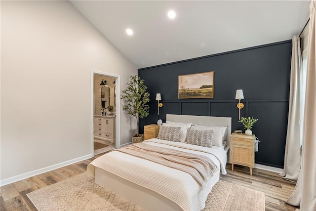 521 E Bird St, Hamilton, MO 64644 - bedroom with wood finished floors, recessed lighting, high vaulted ceiling, and connected bathroom
