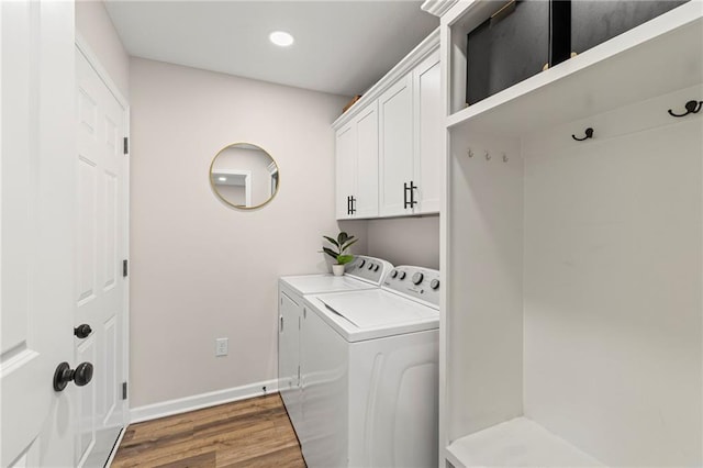 521 E Bird St, Hamilton, MO 64644 - washroom featuring washing machine and dryer, wood finished floors, cabinet space, and recessed lighting