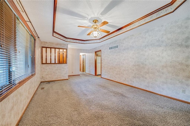 705 Ozark Short Line, Odessa, MO 64076 - spare room with carpet, a tray ceiling, ceiling fan, a textured ceiling, and ornamental molding