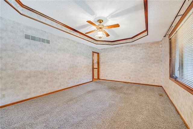 705 Ozark Short Line, Odessa, MO 64076 - carpeted spare room featuring a raised ceiling, ceiling fan, a textured ceiling, and ornamental molding