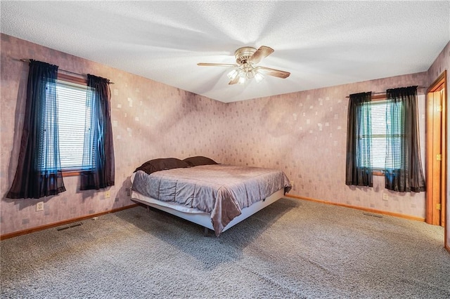 705 Ozark Short Line, Odessa, MO 64076 - bedroom with multiple windows, carpet floors, a textured ceiling, ceiling fan, and wallpapered walls