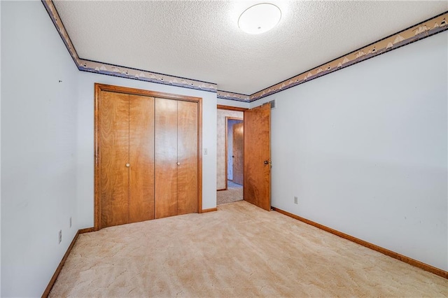 705 Ozark Short Line, Odessa, MO 64076 - unfurnished bedroom with a textured ceiling, carpet floors, and a closet