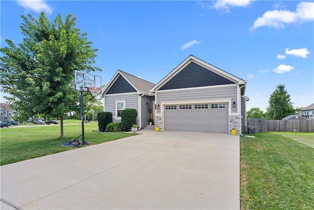 1658 Davis Cir, Eudora, KS 66025 - view of front of home featuring a garage, concrete driveway, and stone siding