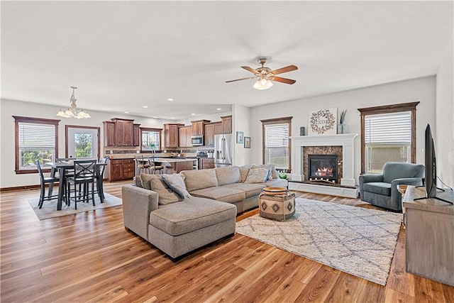 1658 Davis Cir, Eudora, KS 66025 - living room featuring ceiling fan, light wood-type flooring, a chandelier, and recessed lighting