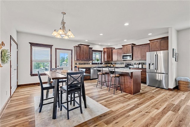 1658 Davis Cir, Eudora, KS 66025 - dining space with a chandelier, light wood-style flooring, and recessed lighting