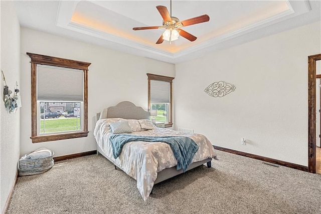 1658 Davis Cir, Eudora, KS 66025 - carpeted bedroom featuring a raised ceiling and a ceiling fan