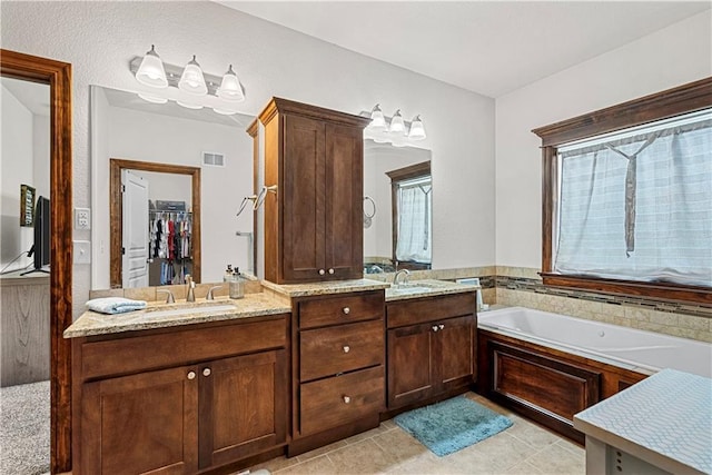 1658 Davis Cir, Eudora, KS 66025 - full bathroom featuring double vanity, a bath, healthy amount of natural light, and tile patterned flooring
